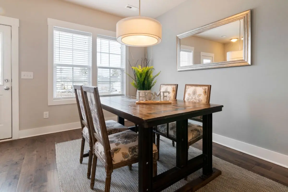 Pendant light hung low over a dining table